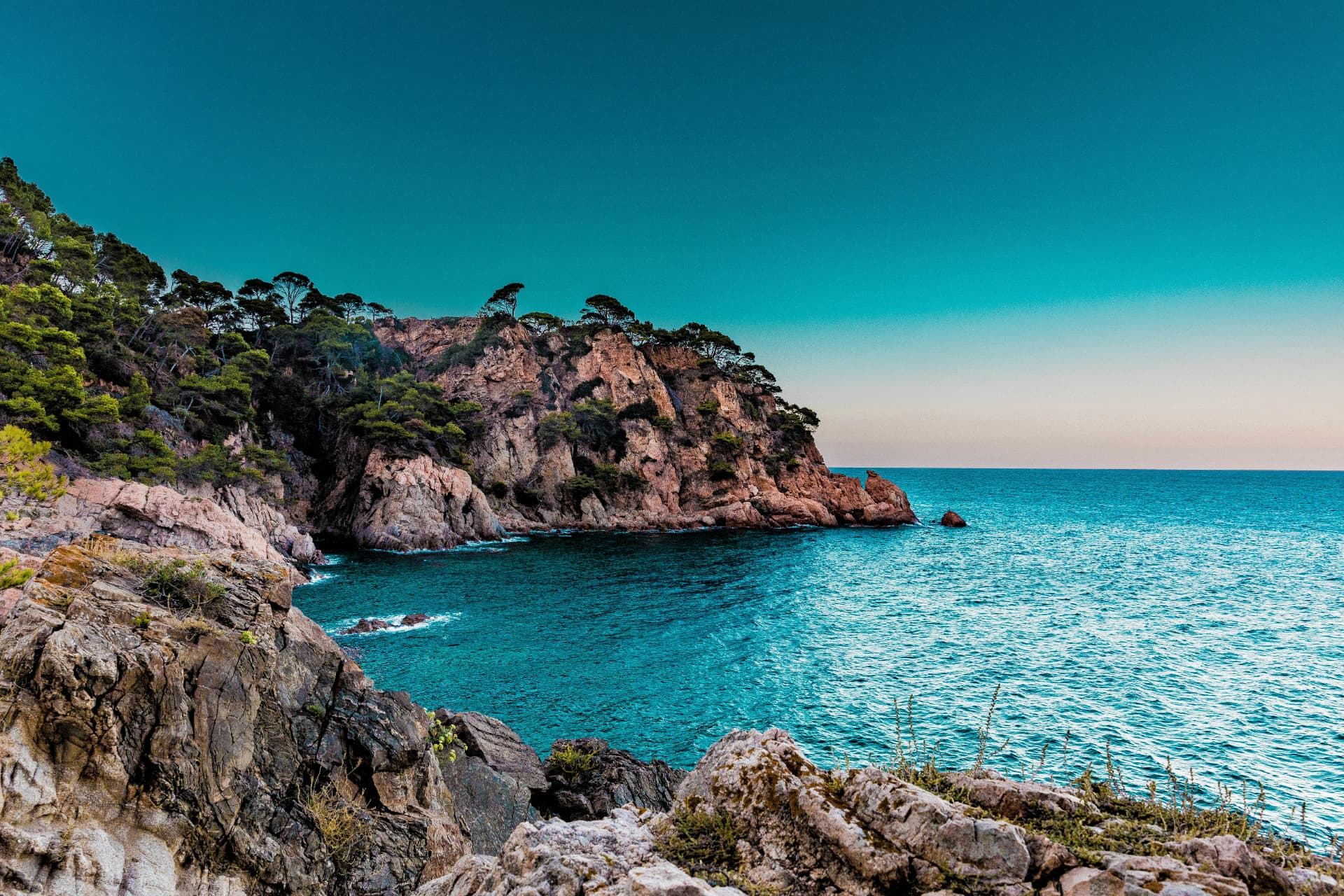 Rocky Costa Brava cove meeting the Mediterranean